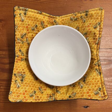 Bees print bowl cosy with a white bowl