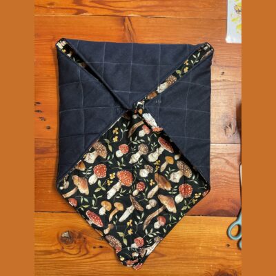 Mushroom insulated casserole carrier closed on a timber table