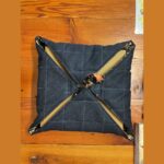 Denim side of a mushroom insulated carrier holding a pizza box