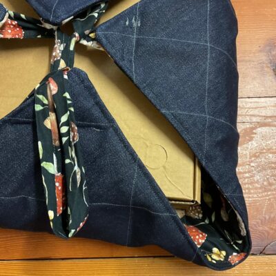 Quilted denim side and mushroom-print ties on a casserole carrier