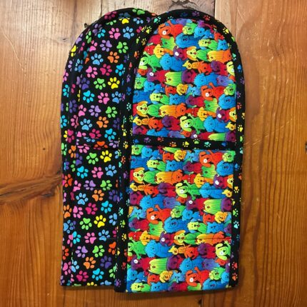 Two handmade double oven mitts in rainbow paw print and rainbow dogs fabrics