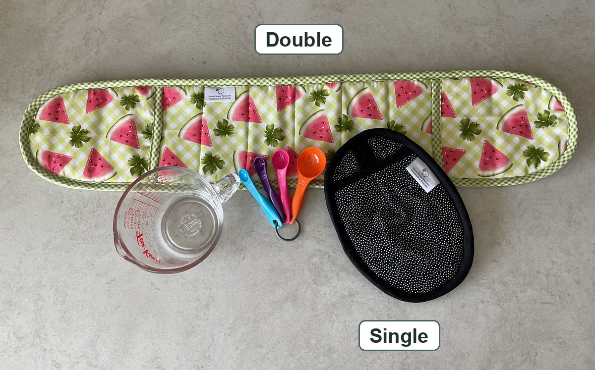 A double oven mitt, one long mitt for two hands, beside a single oven mitt for one hand